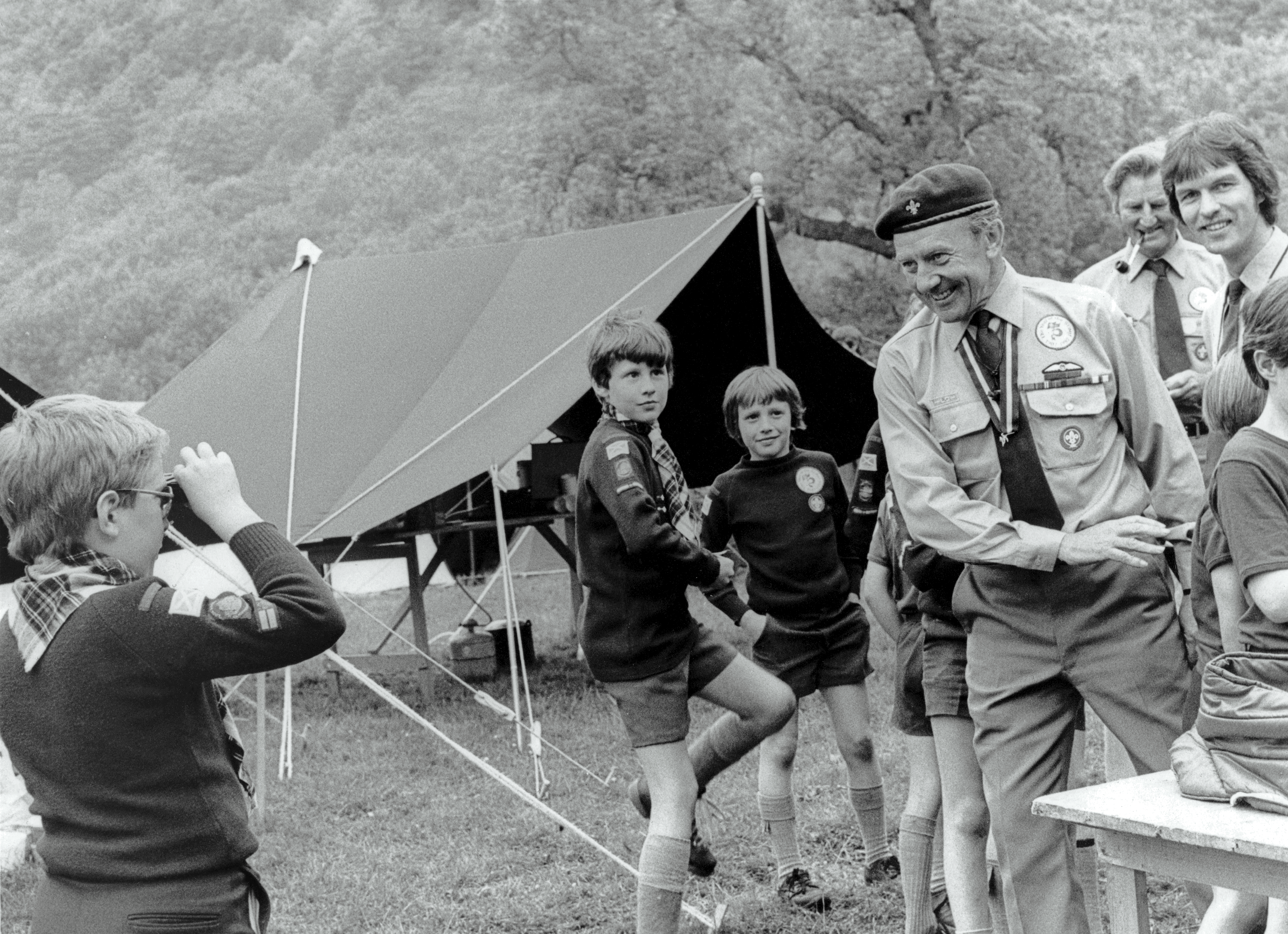 A young Cub Scout taking a photo of the Chief Scout in the 1980s in Scotland. 