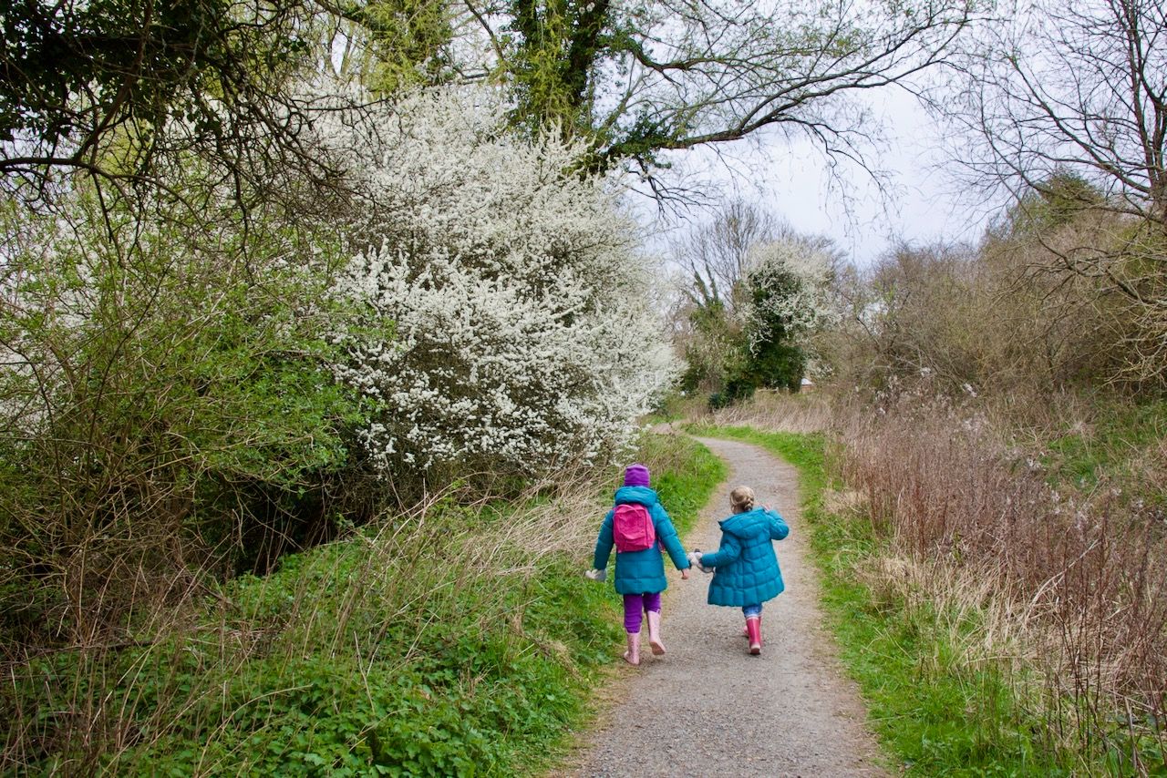 Two girls walking on a path at Woods Mill nature reserve