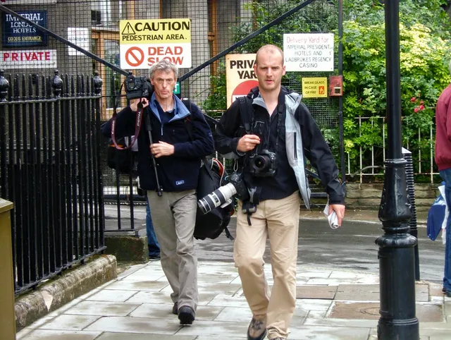 Press photographers seeking a vantage point o photograph the bombed bus on 7th July 2005.